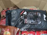 a cardboard box filled with bags of food and a bag of chips