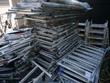a large pile of metal pipes stacked on top of each other