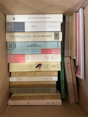 a box full of books that are stacked on top of each other