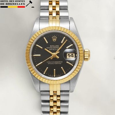 a close up of a wrist watch with a black dial