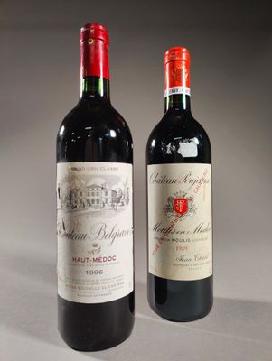 two bottles of red wine sitting next to each other on a table