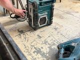 a man that is working on a machine in a room