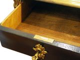 a wooden box with a brass handle on it