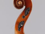 a close up of the back of a violin with a fiddle in the foreground