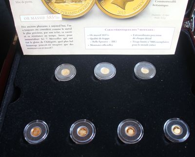 a box of gold coins with a picture of a man on it