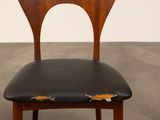 a wooden chair with a black seat and a black seat pad