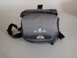 a small bag with a logo on it sitting on a table