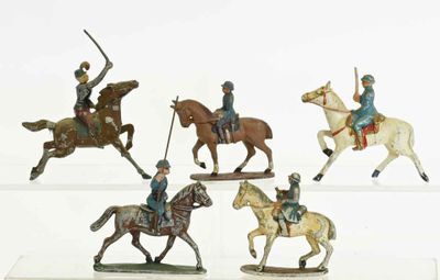 five figurines of men riding horses on a white surface
