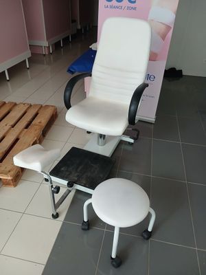 a chair and a stool in a room with pallets