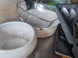 several bowls and spoons are sitting on a table with utensils