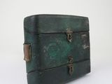 a small green suitcase sitting on top of a white table