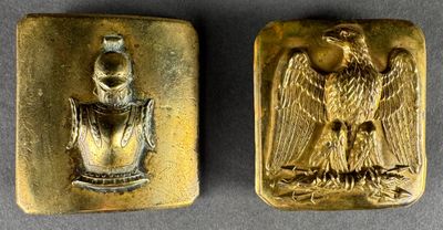 two pieces of gold with an eagle and a bird on it