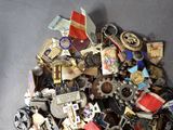 a pile of assorted badges and other items on a table