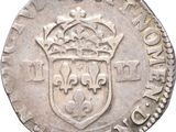 a silver coin with a crown on top of it
