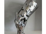 sculpture of a cow head made of metal on a metal base