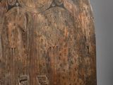 an old wooden carving of a person with a bird on it ' s back