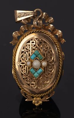 a close up of a gold locke with a turquoise stone in it