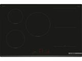 une plaque de cuisson noire à trois feux et trois boutons