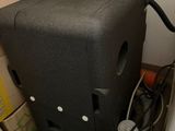 a black speaker sitting on top of a pile of boxes