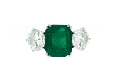 an emerald and diamond three stone ring