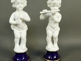 pair of porcelain figurines of a boy and a girl playing the flute