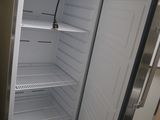 an empty refrigerator in the corner of a kitchen
