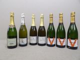 six bottles of wine are lined up on a table