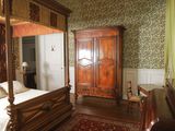 a bedroom with a four poster bed and a dresser in it