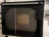 a microwave sitting on top of a table in a kitchen