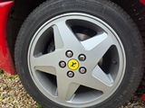 a close up of a tire on a red sports car
