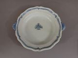 a blue and white plate with a tree on it