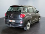 the back end of a small black car parked in a room
