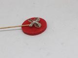 gold plated dragonfly brooch pin on a red velvet surface
