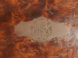 a close up of a wooden box with a name on it