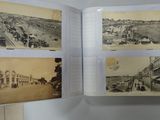 a person holding a book open to show pictures of a town