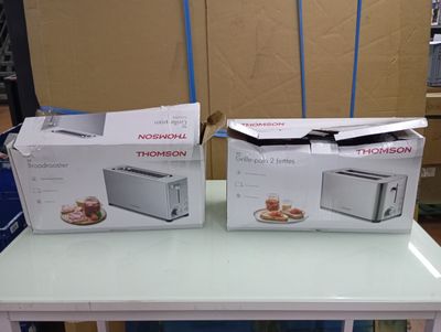 two boxes of microwaves sitting on top of a table next to each other