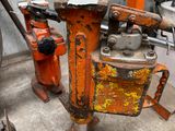 a rusted orange fire hydrant sitting in the middle of a room