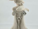 statue of a woman sitting on top of a fountain on a white background