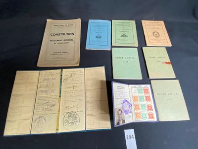 some old papers are sitting on a table with stamps and stamps