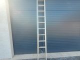 a ladder leaning against a garage door in front of a garage door