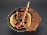 a bowl with a watch and a banana in it