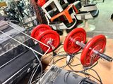 two red dumbs sitting on a table next to a laptop