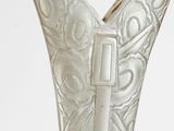 a close up of a silver vase on a table