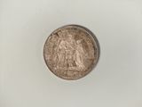 an old silver coin with a picture of a woman on it