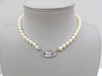 pearl and diamond necklace with evil eye charm