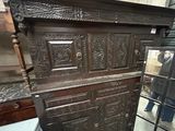 a large wooden chest sitting in a room with a mirror