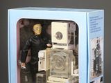 a toy robot in a box that is sitting on a table