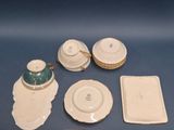 a blue table with white plates and a teapot on it