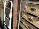 a stack of boxes and a ladder in a room