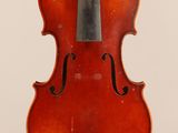 an old violin with a bow hanging from it ' s back
